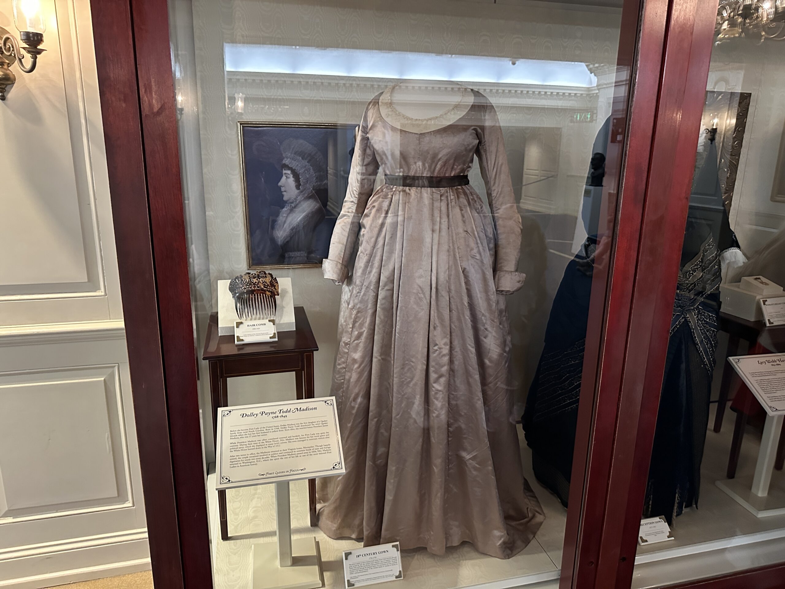 Over in the first ladies display case is a new portrait, dress, and hair comb that belonged to Dolley Payne Todd Madison, wife of President James Madison. Previously, a different Dolley Madison portrait and dress were on display here.