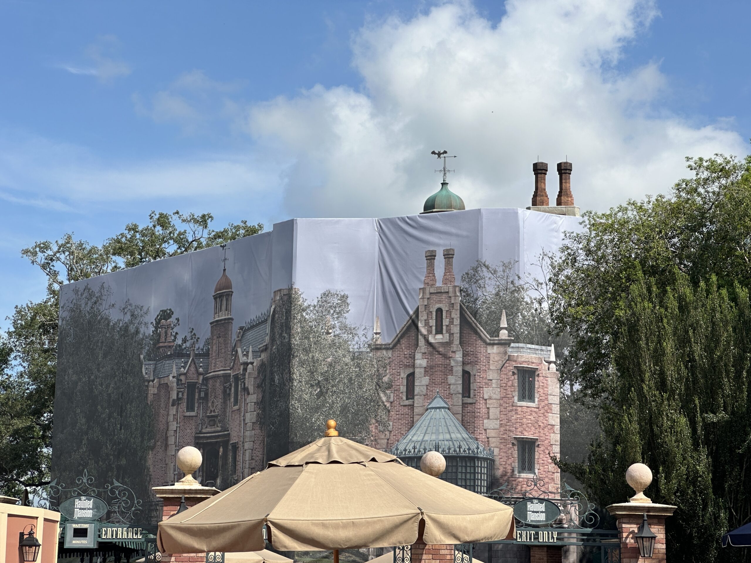 Scrims and scaffolding went up around the chimneys in March. Though scaffolding came down from one pair of chimneys in June, it went back up soon after. The scaffolding is now gone again, and it looks like the chimneys have darker detail paint, making them look more realistically burnt and soot-covered.