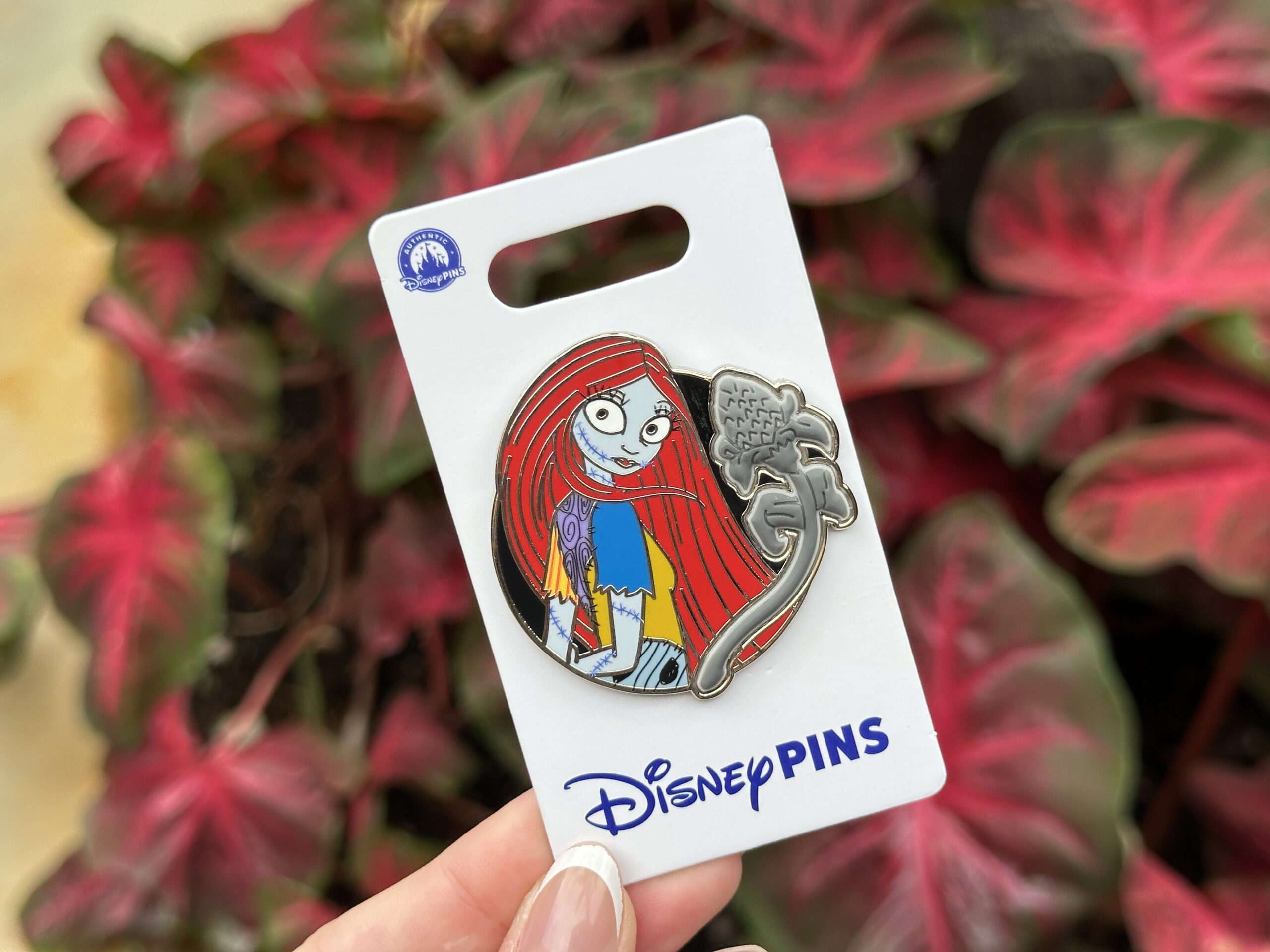 Sally is pictured looking over her shoulder alongside a gray silicone flower.