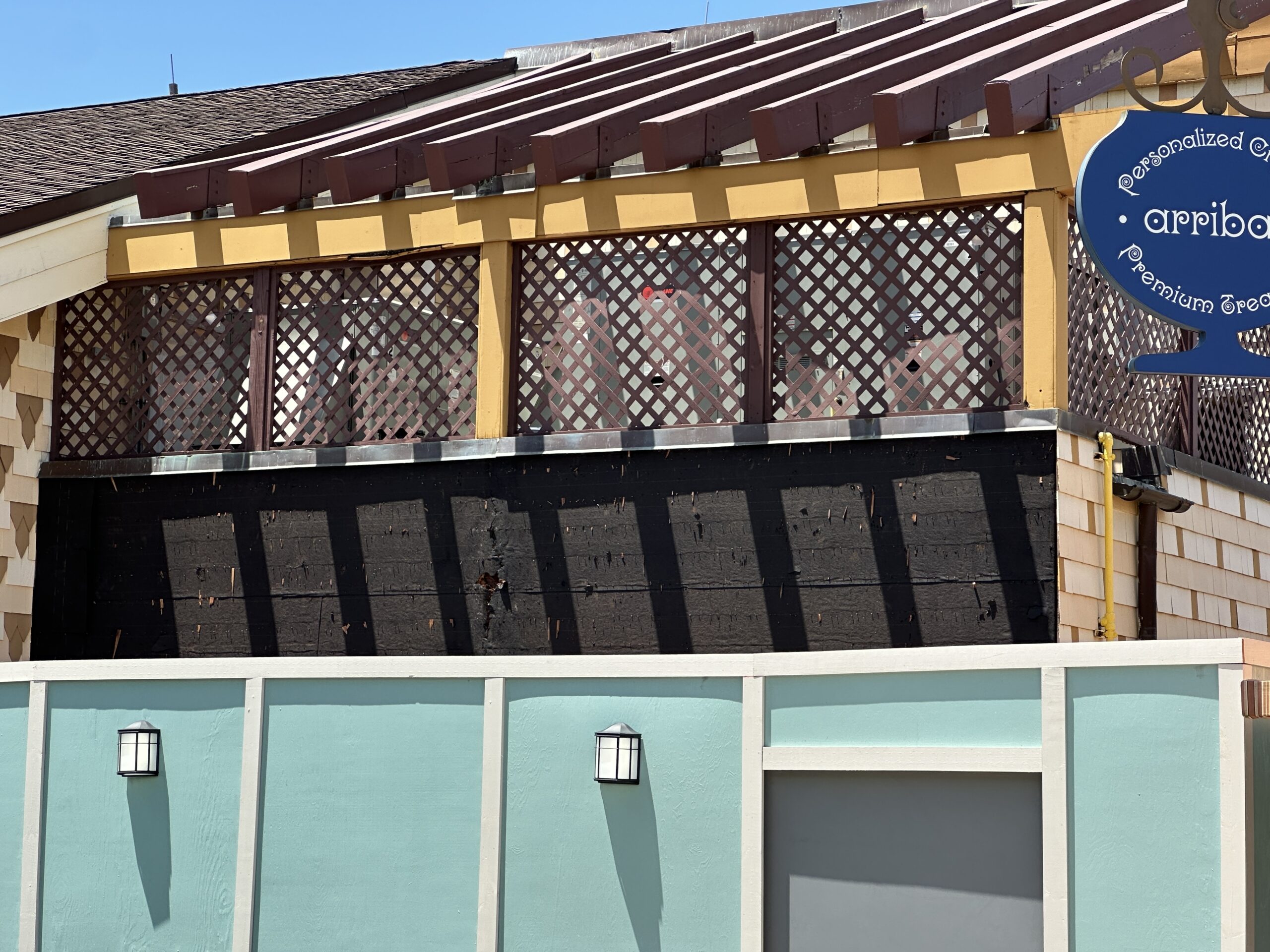 The paneling that was removed had the same design as the paneling still visible on the back of the building. There's not just black sheathing exposed.