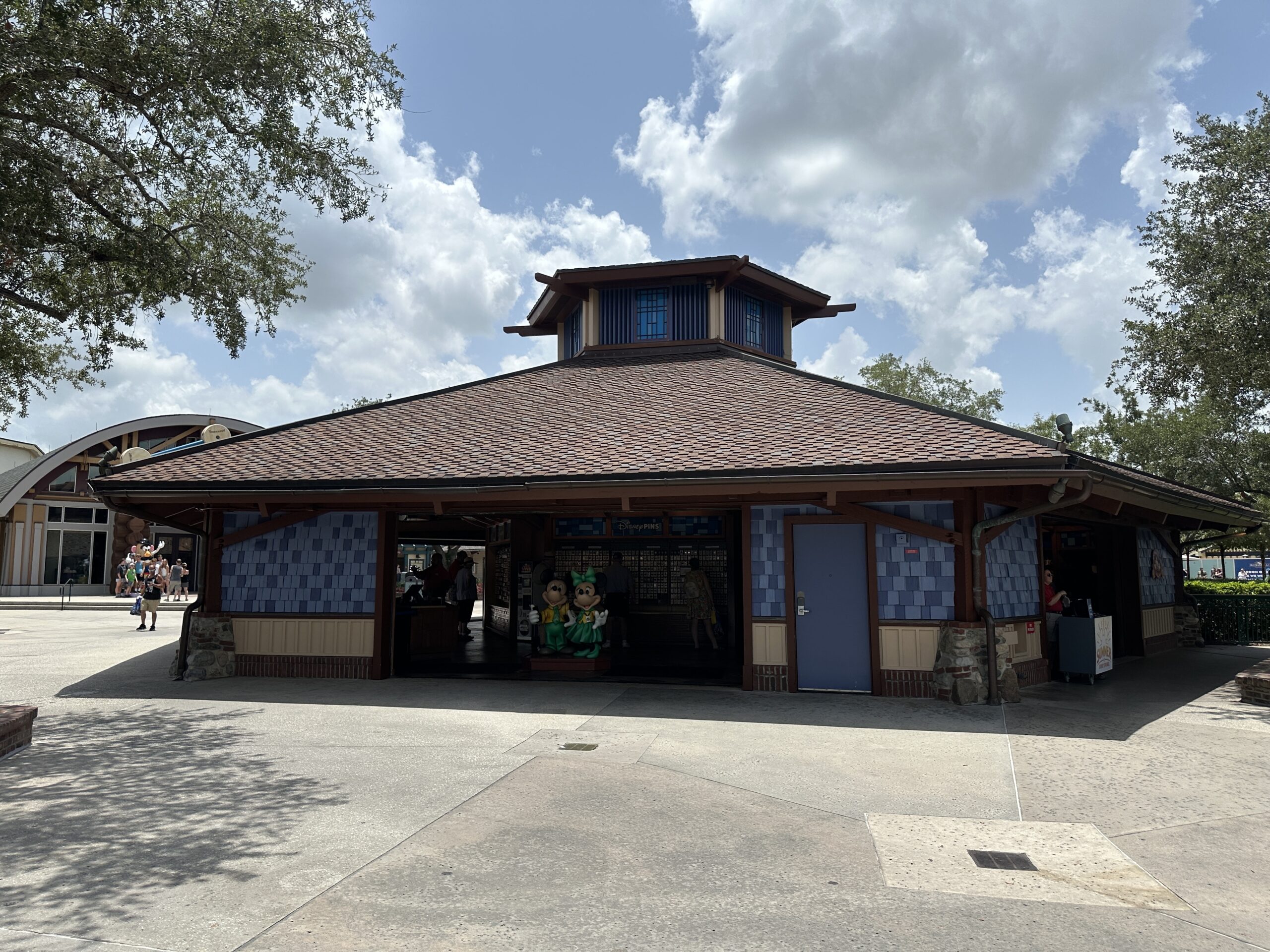 The repainting of Disney's Pin Traders at Disney Springs appears to be complete. The painting project began in June and has turned the formerly orange building blue.