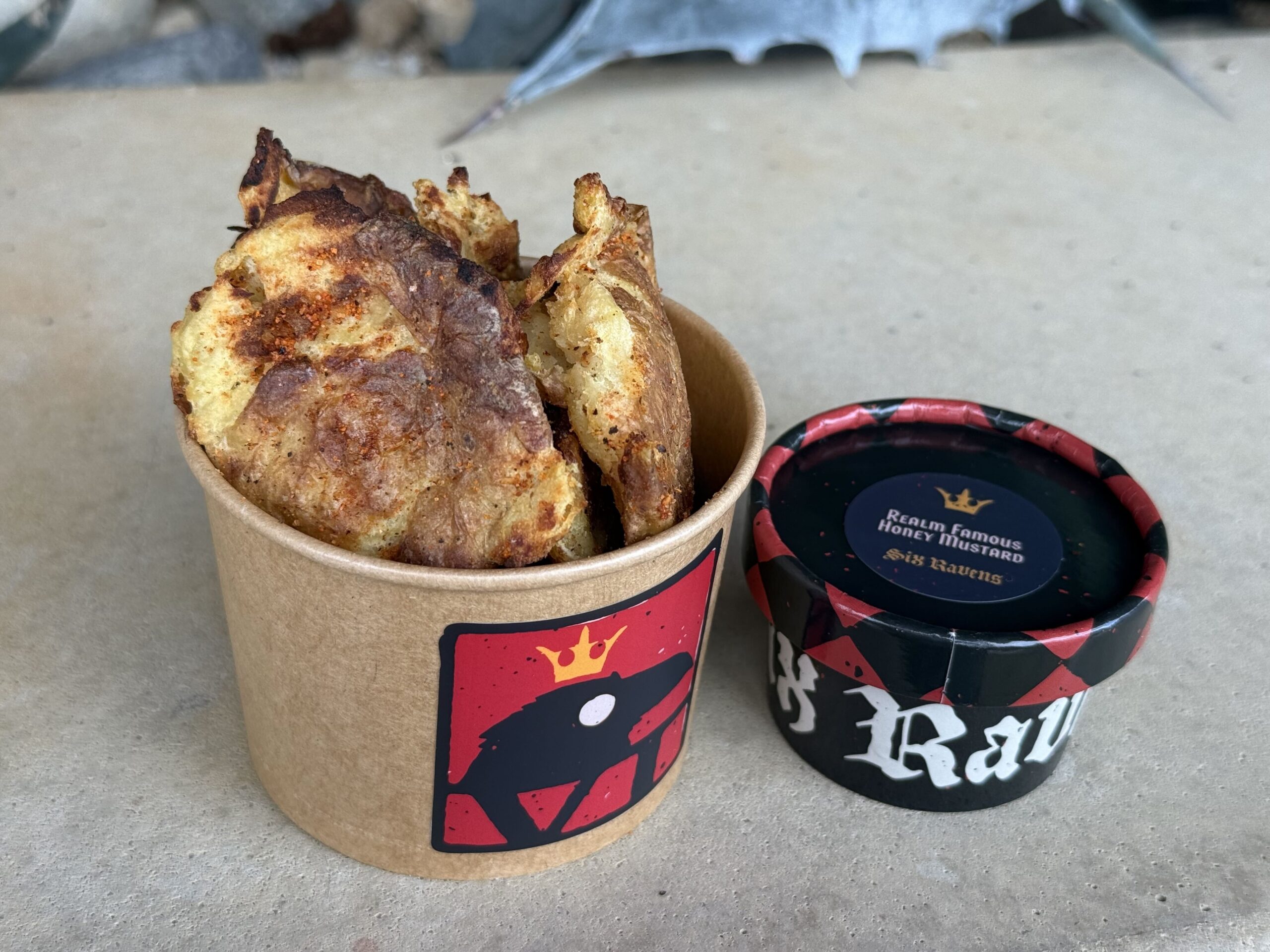 A mini bucket of Baked Smashed Potatoes perfectly seasoned with the King’s spices and served with our Realm Famous Honey Mustard.