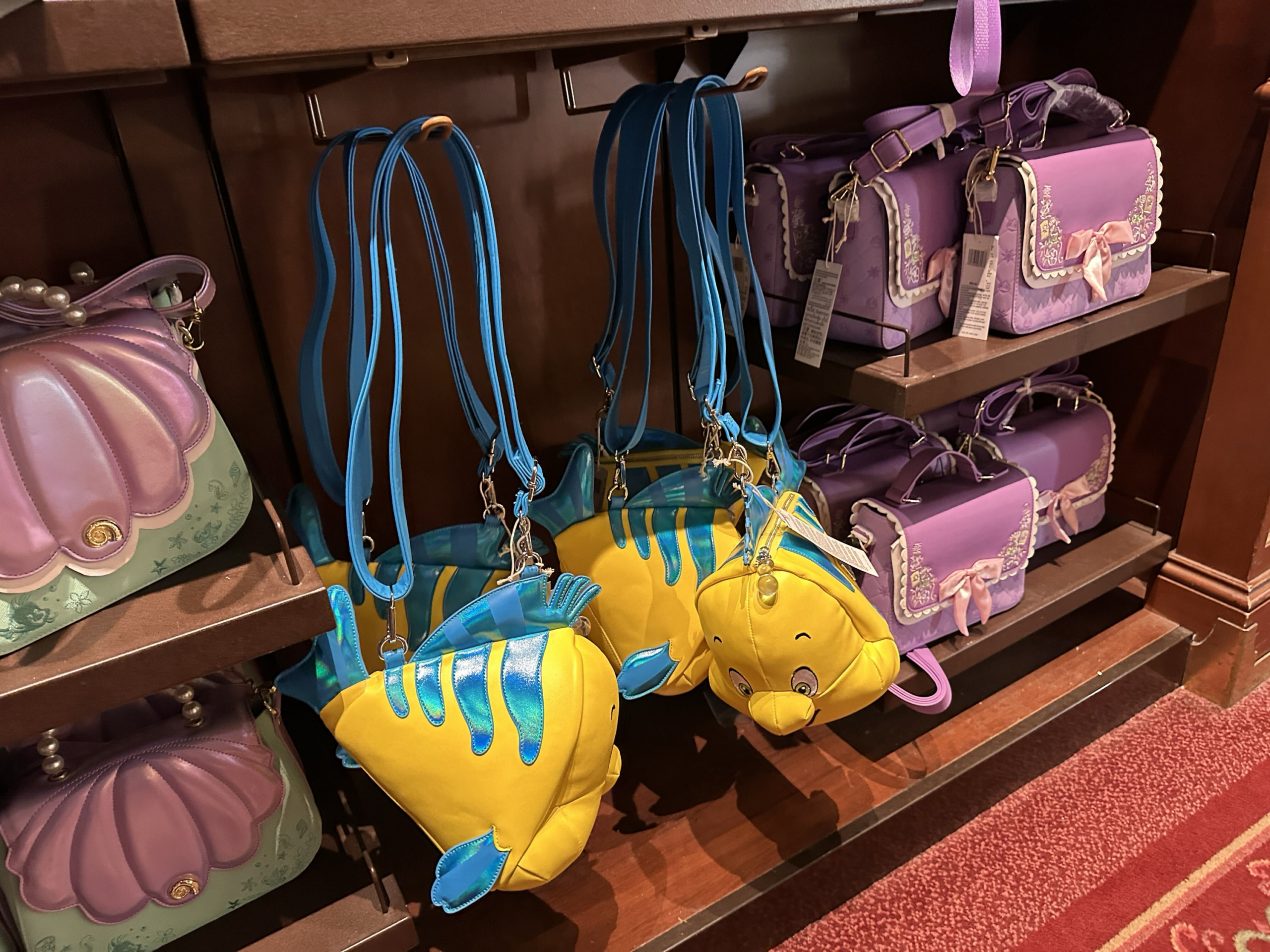 A new Flounder crossbody bag has swam into Magic Kingdom.