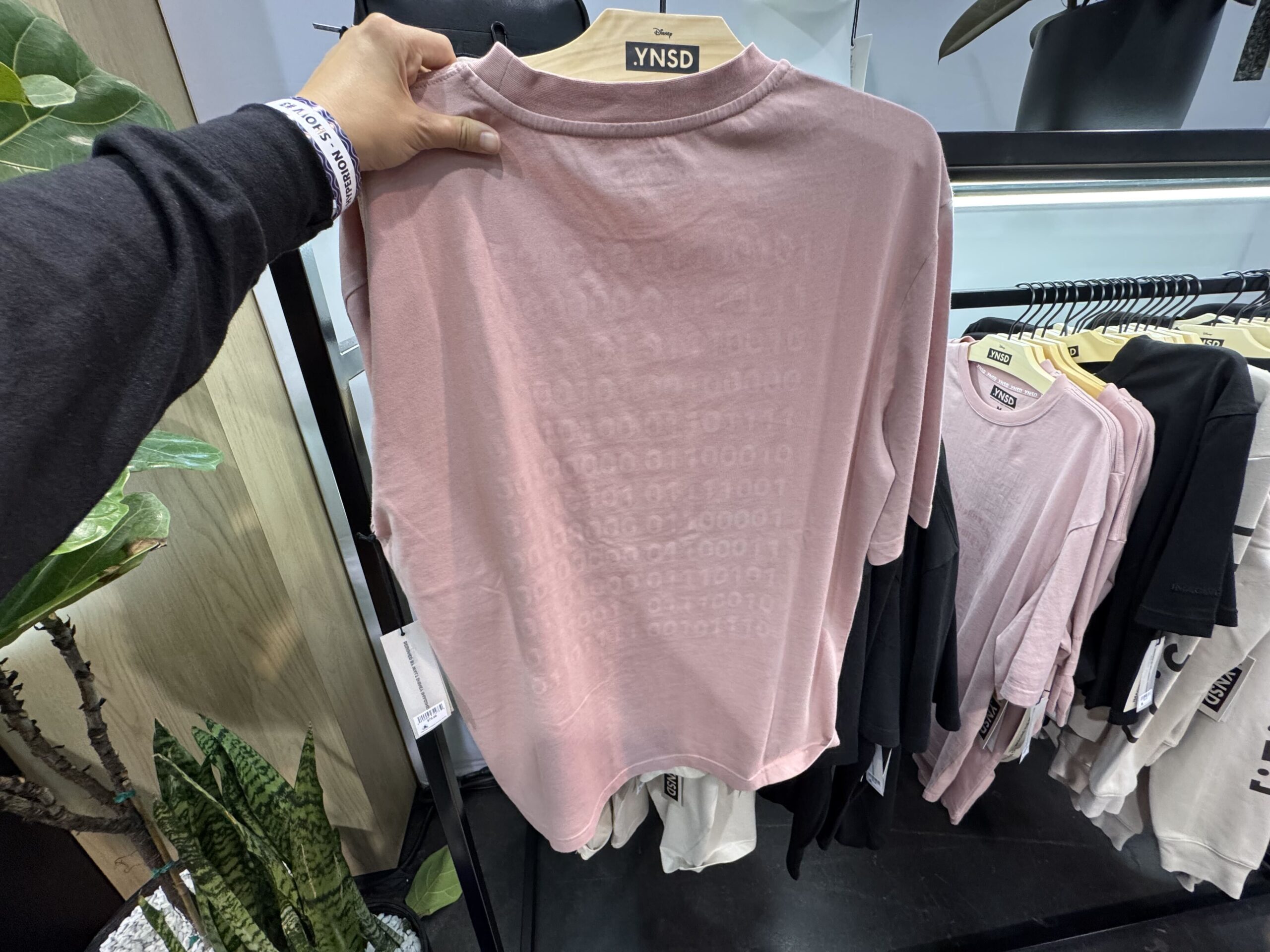 This UV-activated pink shirt has an image of Sorcerer Mickey on the front, and an image of Sorcerer Mickey and the logo on the back.