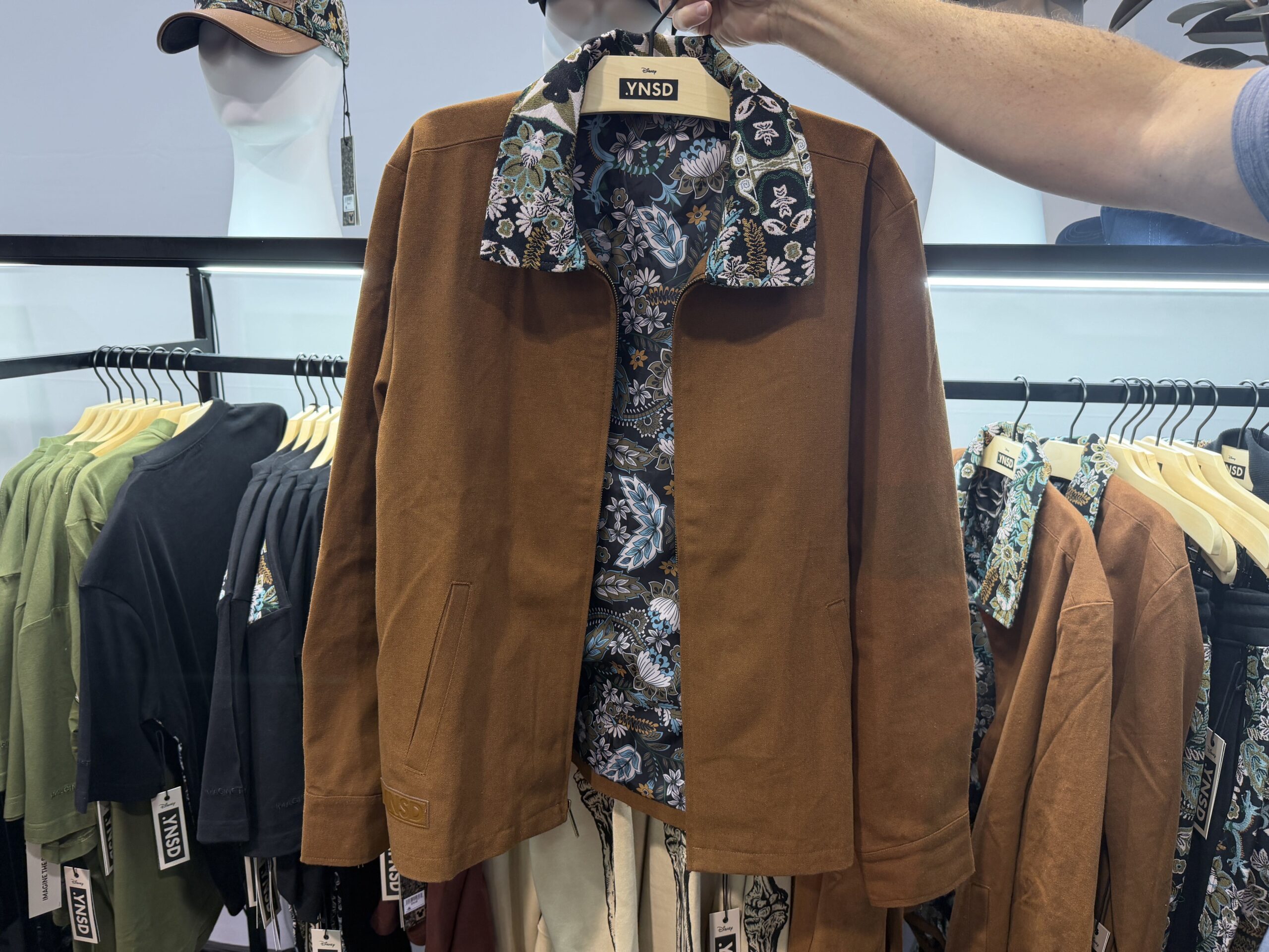 A dark tan worker jacket has the carpet print on the collar and interior lining.