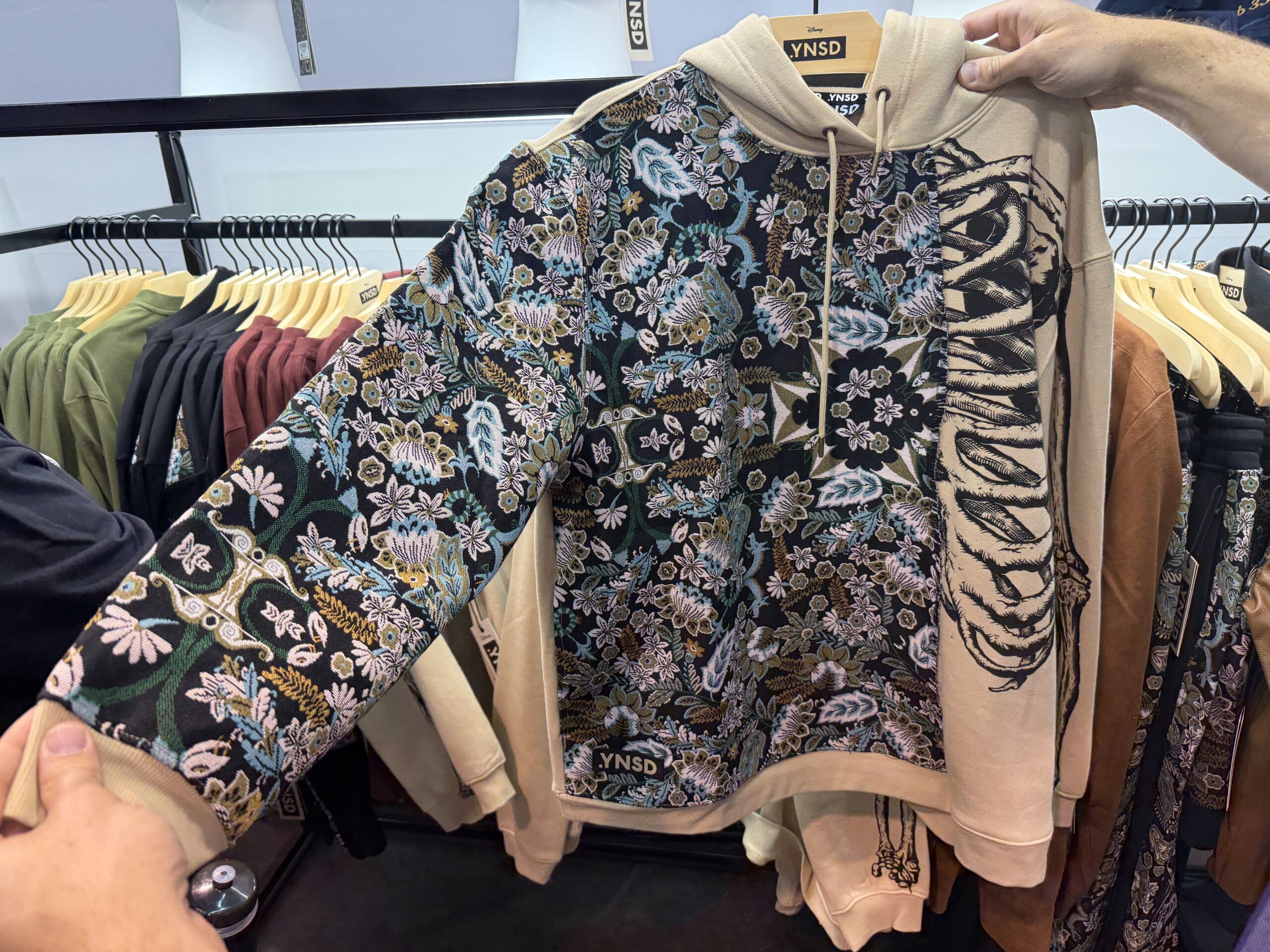 One side of the cream hoodie has the carpet print, while the other has a ribcage.