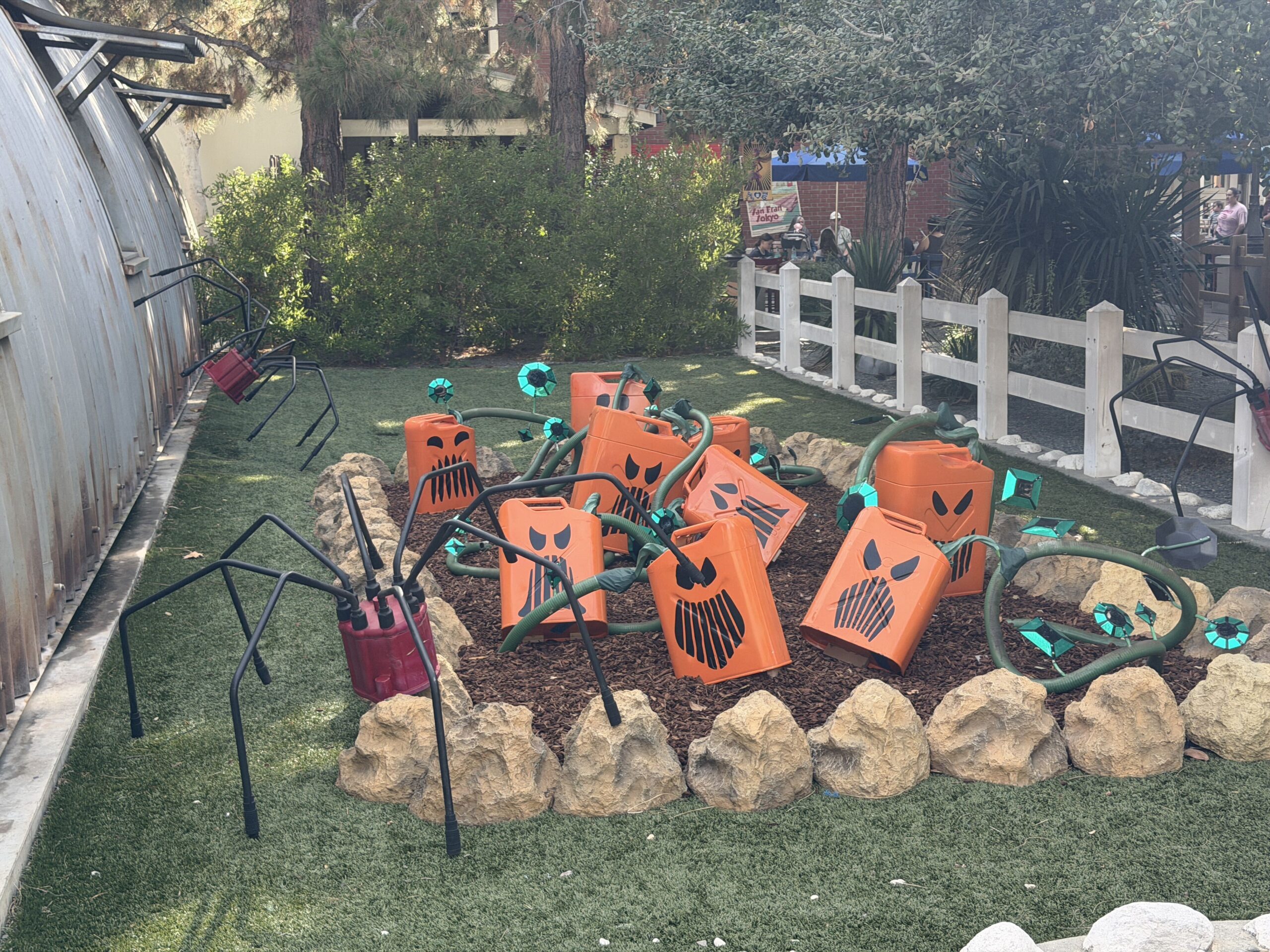 Pumpkin-faced batteries are wired as though growing from vines in the ground, and oil can spiders climb trees and scurry about.