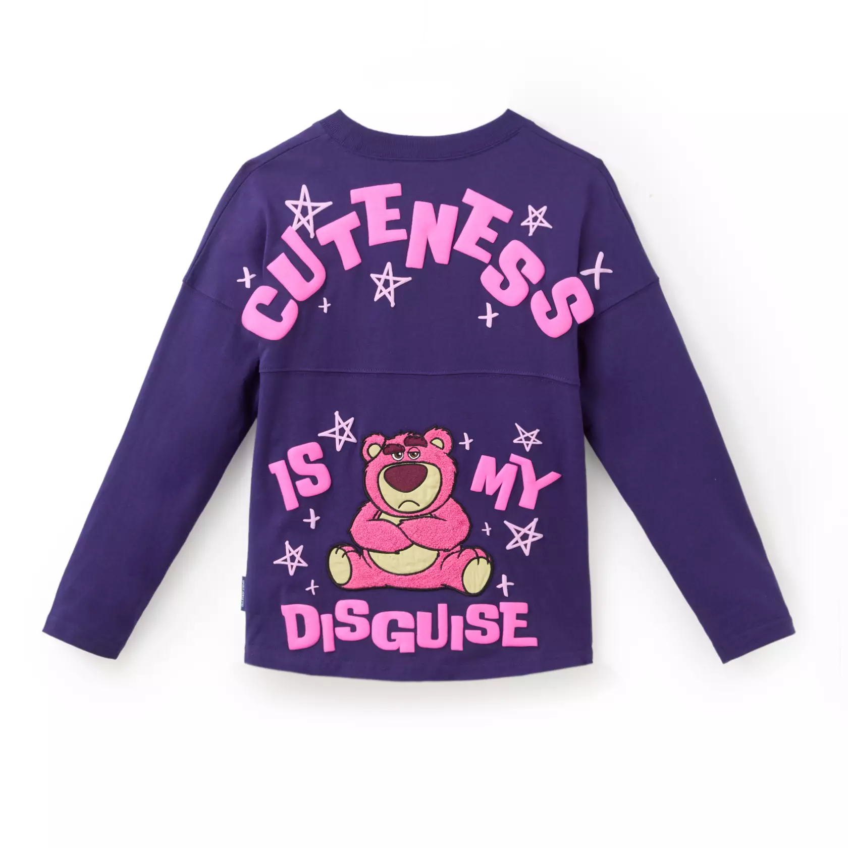 Inspired by Lots-o'-Huggin' Bear from Toy Story 3, this purple jersey is adorned with puffy ink details and screen art of Lotso smirking on the chest. An embroidered chenille and satin appliqué of the pink bear is on the back with "Cuteness is my disguise" in puffy ink.