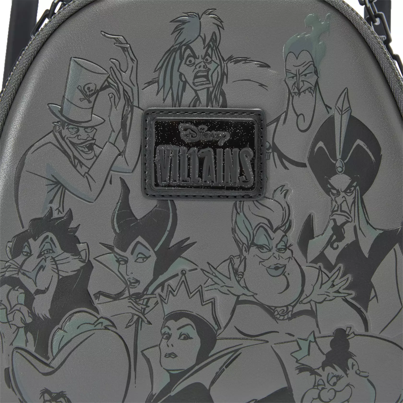 This gray faux leather backpack has black straps and trim plus a detachable chain handle. Screen art on the front includes the Evil Queen, Maleficent, Captain Hook, Cruella De Vil, Ursula, Jafar, Scar, Hades, Doctor Facilier, and the Queen of Hearts. Printed flames are on the sides.
