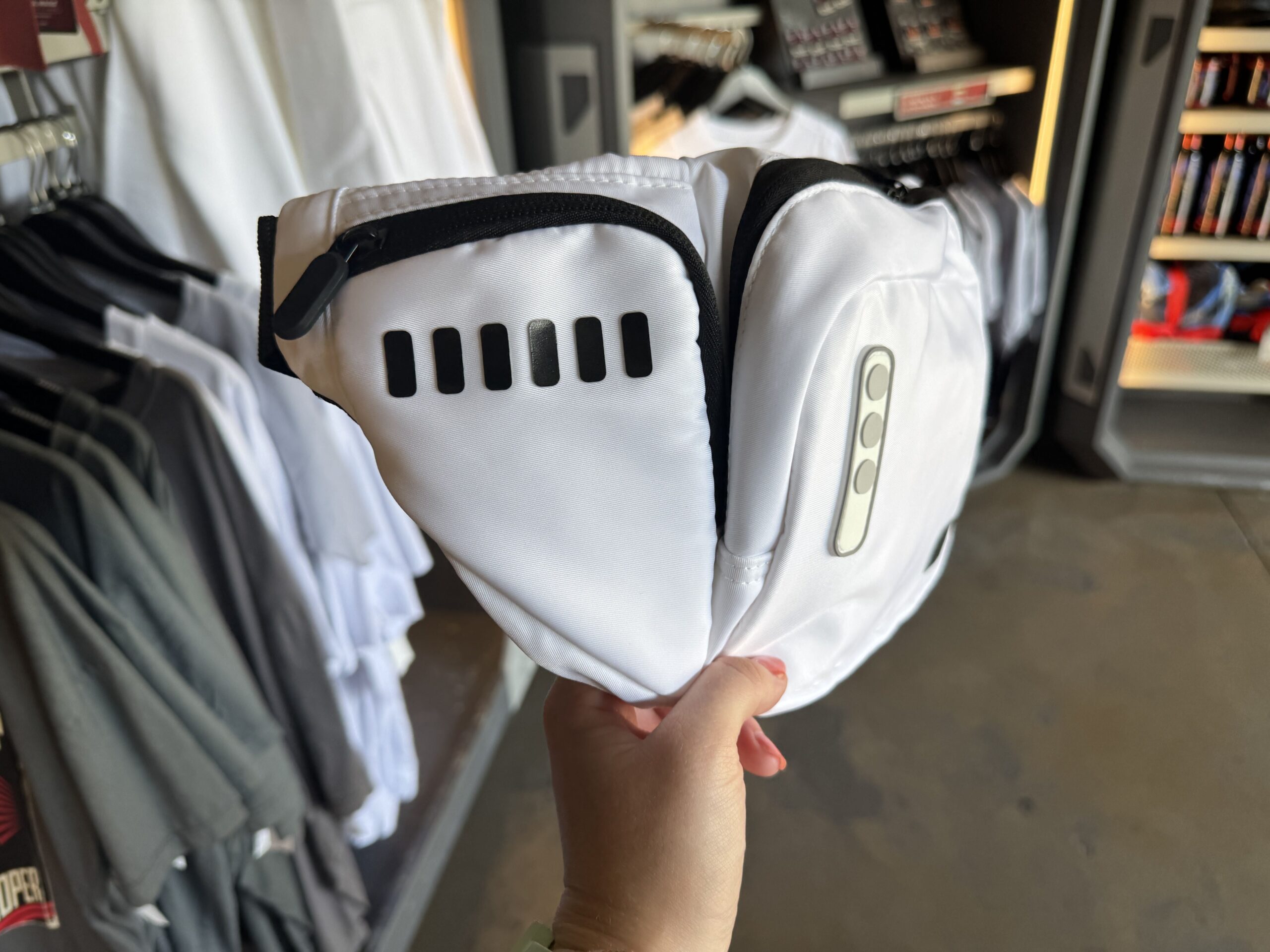 This belt bag emulates the look of a Stormtrooper and is made of white nylon with black stitching and zipper details. Black and white synthetic material decorates the front and side of the bag like the buttons and ventilation of Stormtrooper armor.