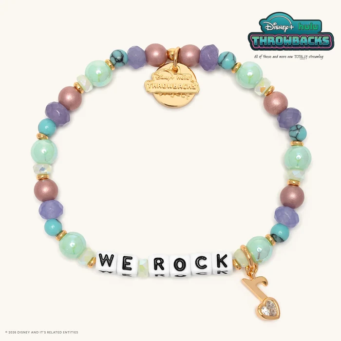 The beads on this bracelet are in various shades of pink, purple, and aqua with "WE ROCK" spelled out with white letter beads. The bracelet comes with a gold music note that has a heart-shaped clear gem in the notehead. Each bracelet in the collection come with a gold-plated "Disney+ Hulu Throwbacks" charm as well.