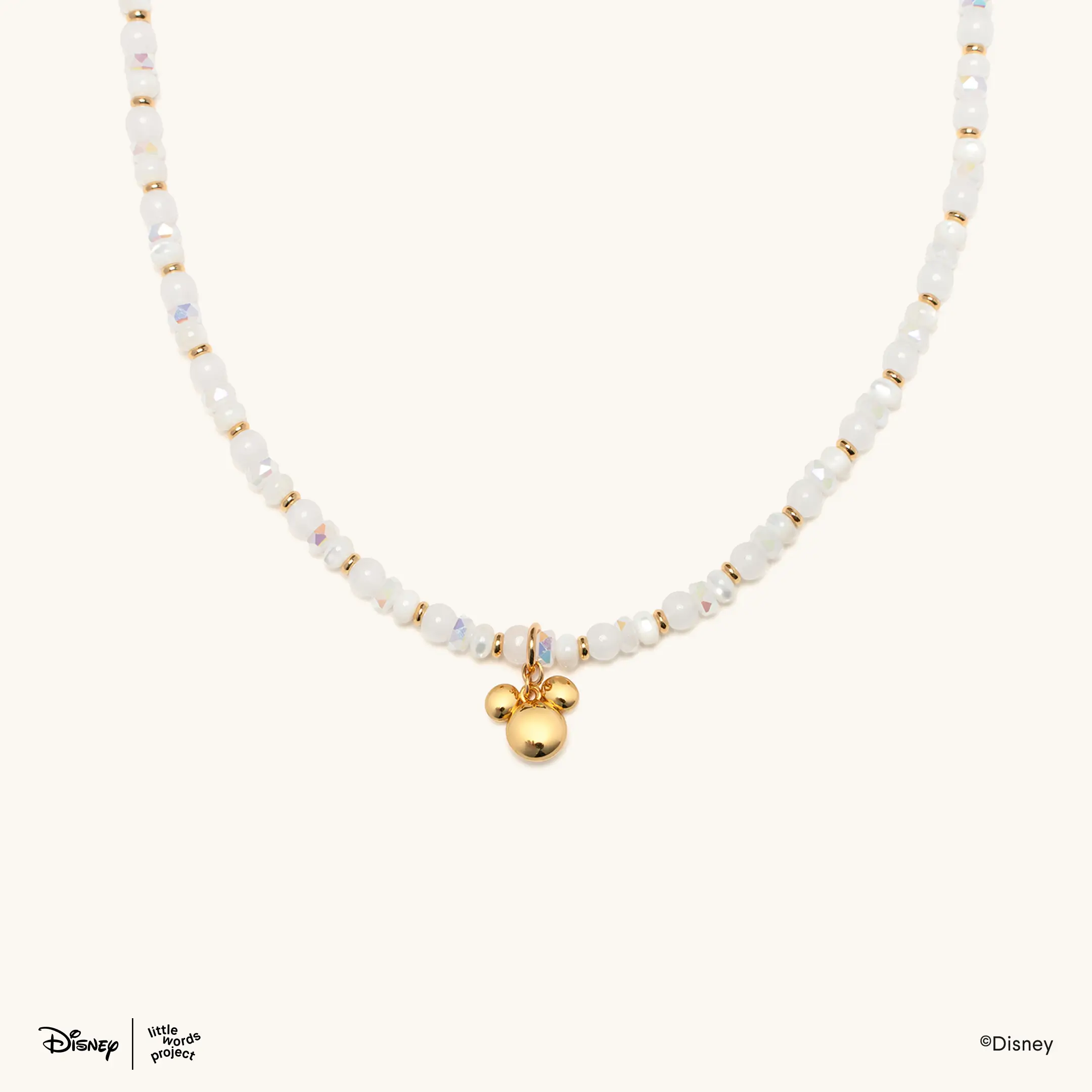 This necklace comes with white and clear beads and a dangling gold Mickey head charm.