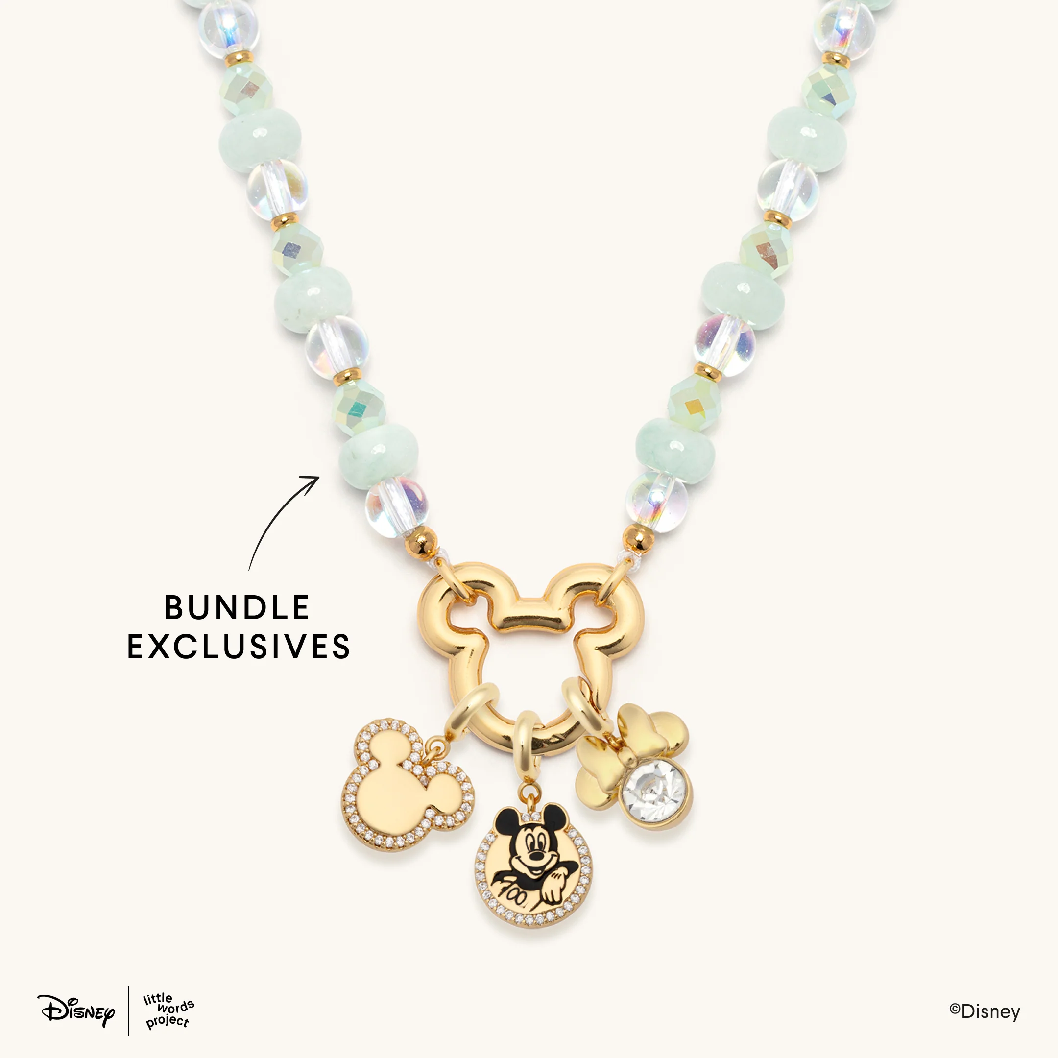 This necklace is made with clear and sea foam green beads connected to a gold Mickey head-shaped ring. Attached to the ring are the three Mickey and Minnie charms from the previous charm bundle.