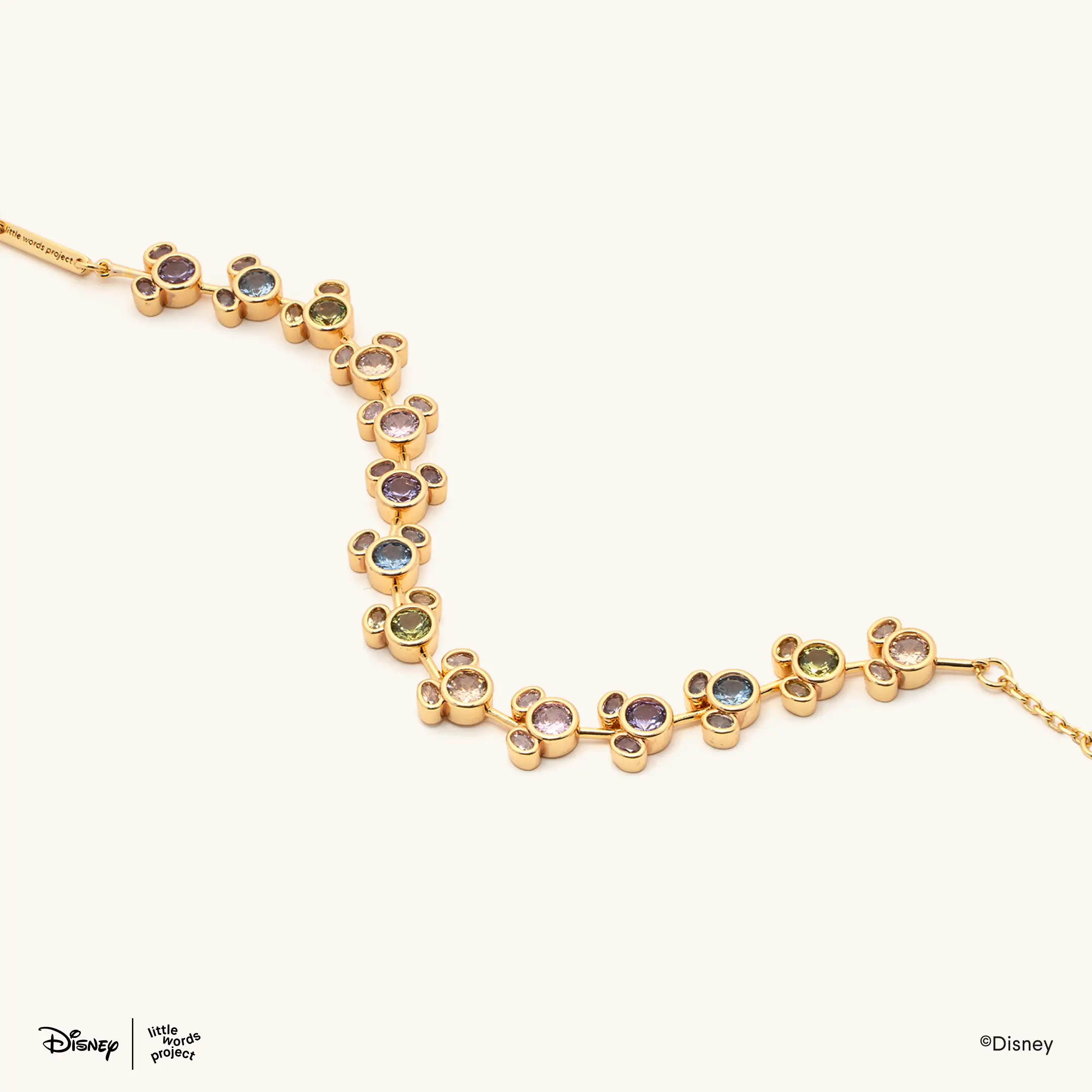 This bracelet has a strand of gold Mickey heads filled with gems of all different colors of the rainbow.