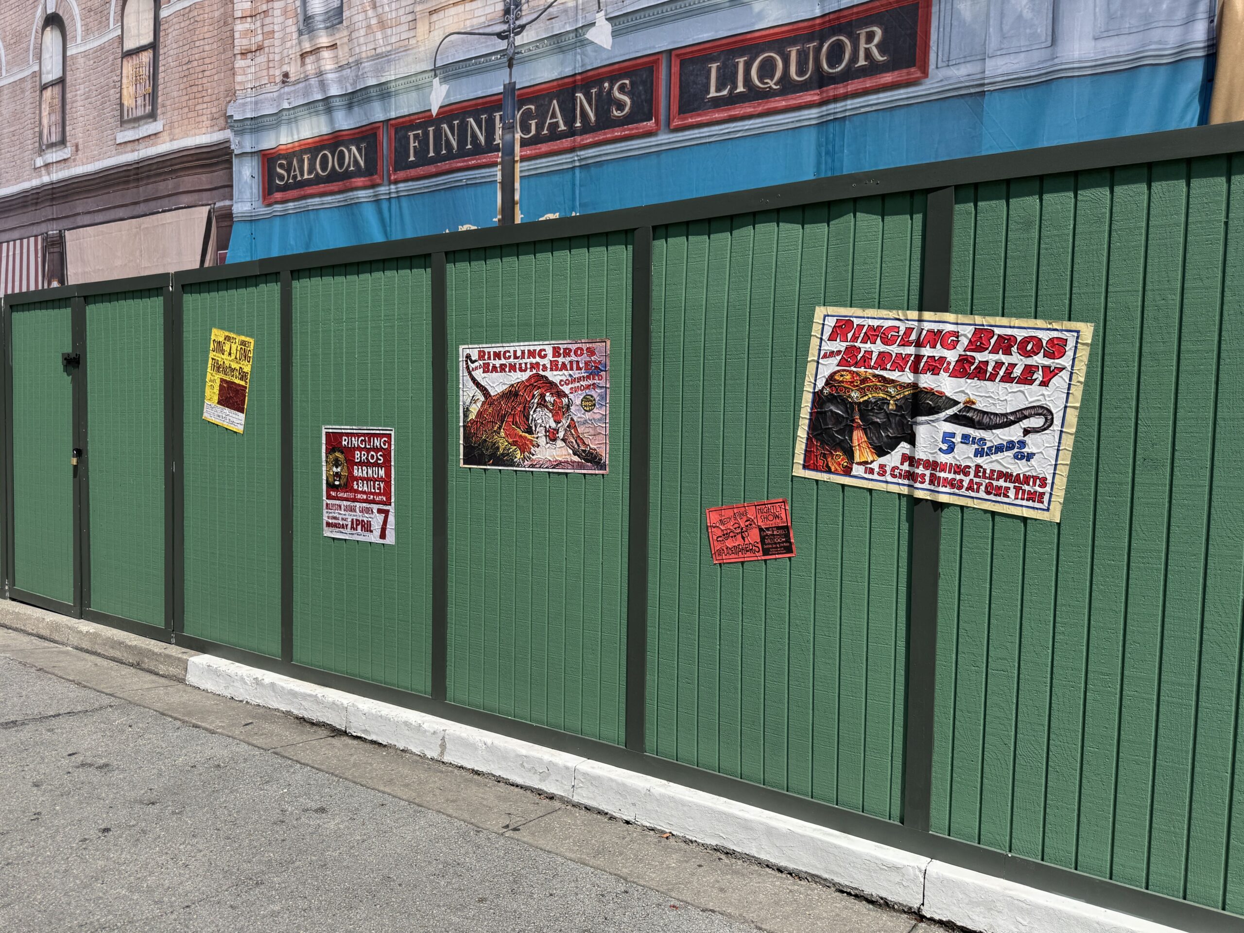 Halloween Horror Nights set designers are making use of the Finnegan's construction walls. Various vintage-style Ringling and Barnum & Bailey posters adorn the walls.