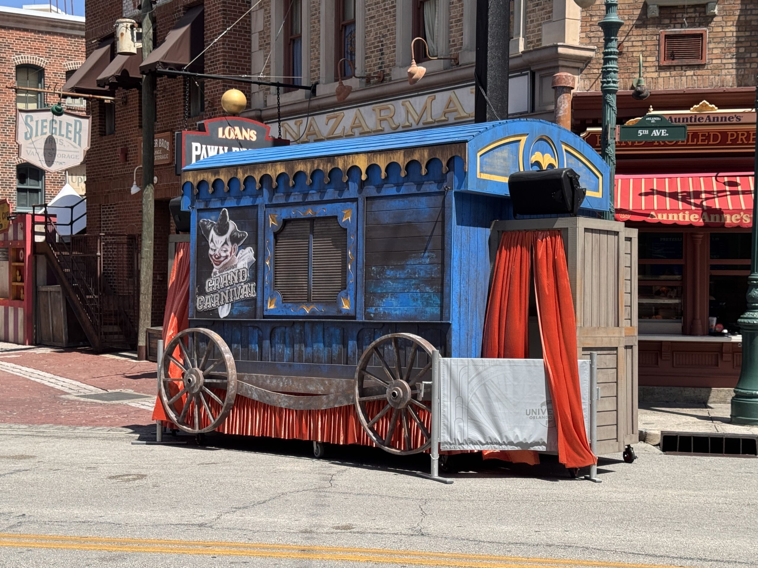 One of the blue wagons in the area has red curtains and "Dr. Oddfellow's Grand Carnival" artwork on the side. This wagon has moved locations multiple times. It now sits at the head of Sting Alley.