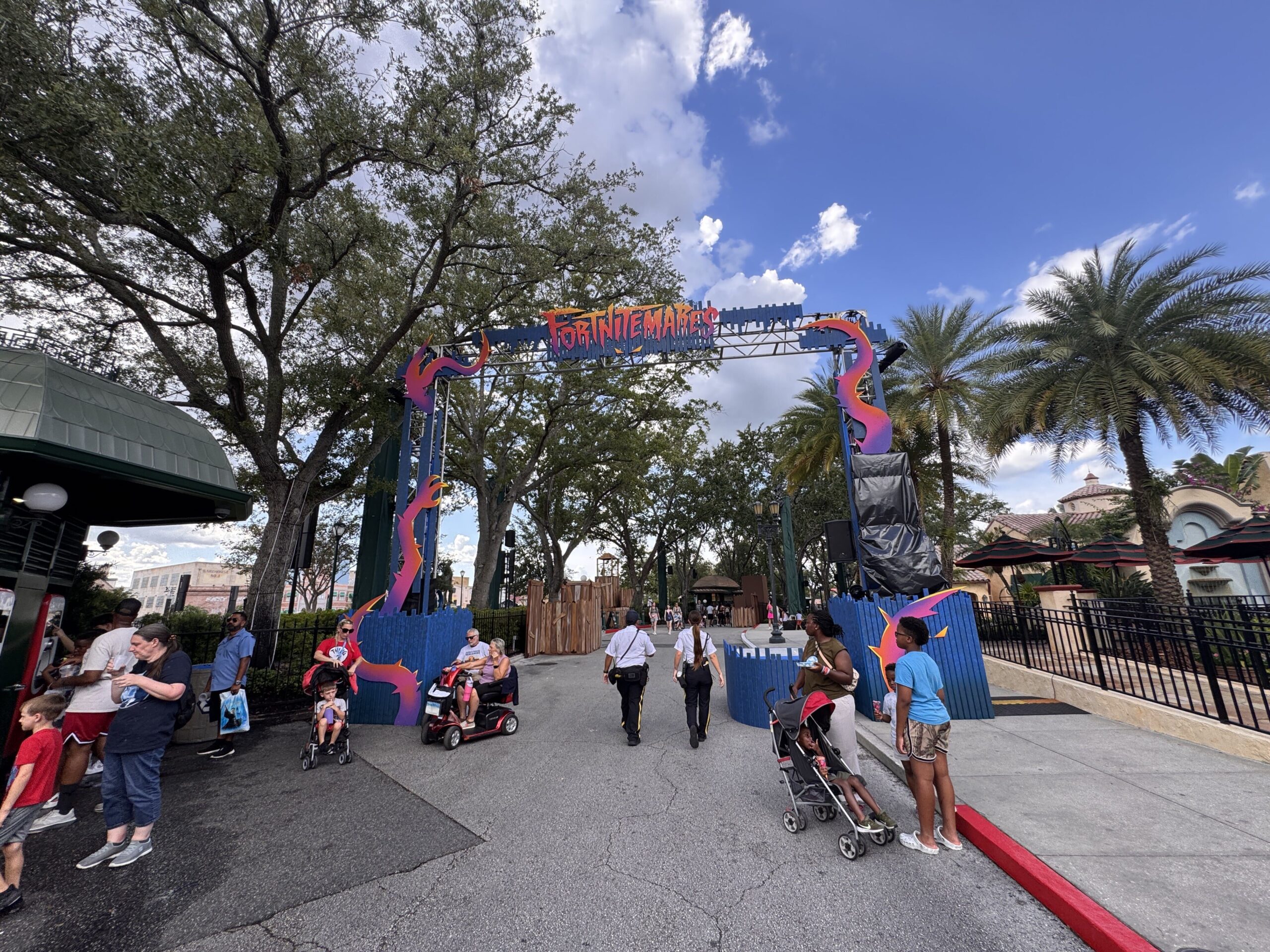 Last but not least for scare zones is FORTNITEMARES in the Central Park area. Trusses at the entrance are adorned with blue paneling and tentacle-like elements. A "FORTNITEMARES" sign is at the top.