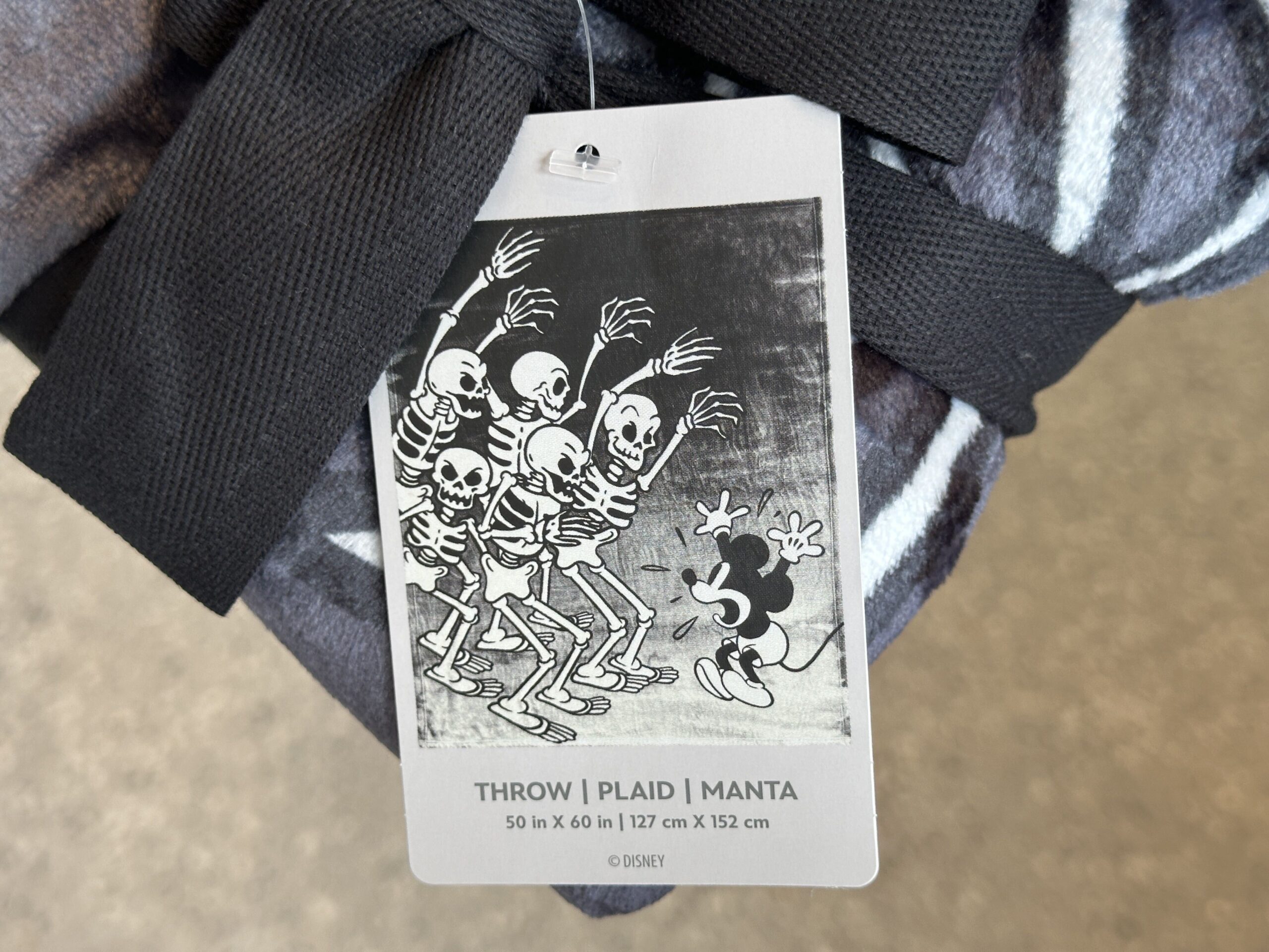 This grayscale plush throw blanket shows Mickey being scared by the skeletons. It measures 50 by 60 inches.
