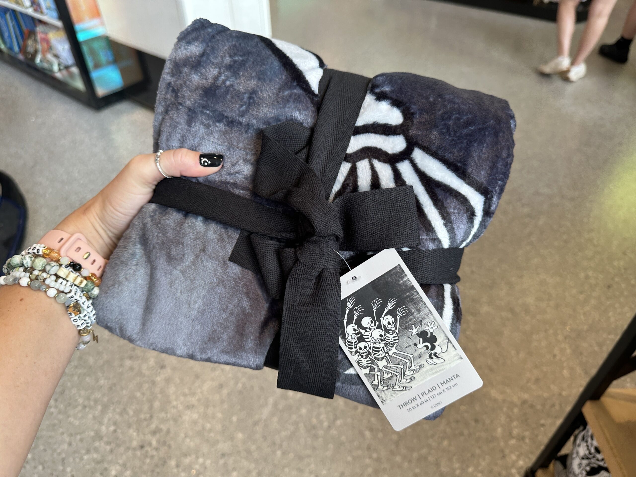 This grayscale plush throw blanket shows Mickey being scared by the skeletons. It measures 50 by 60 inches.