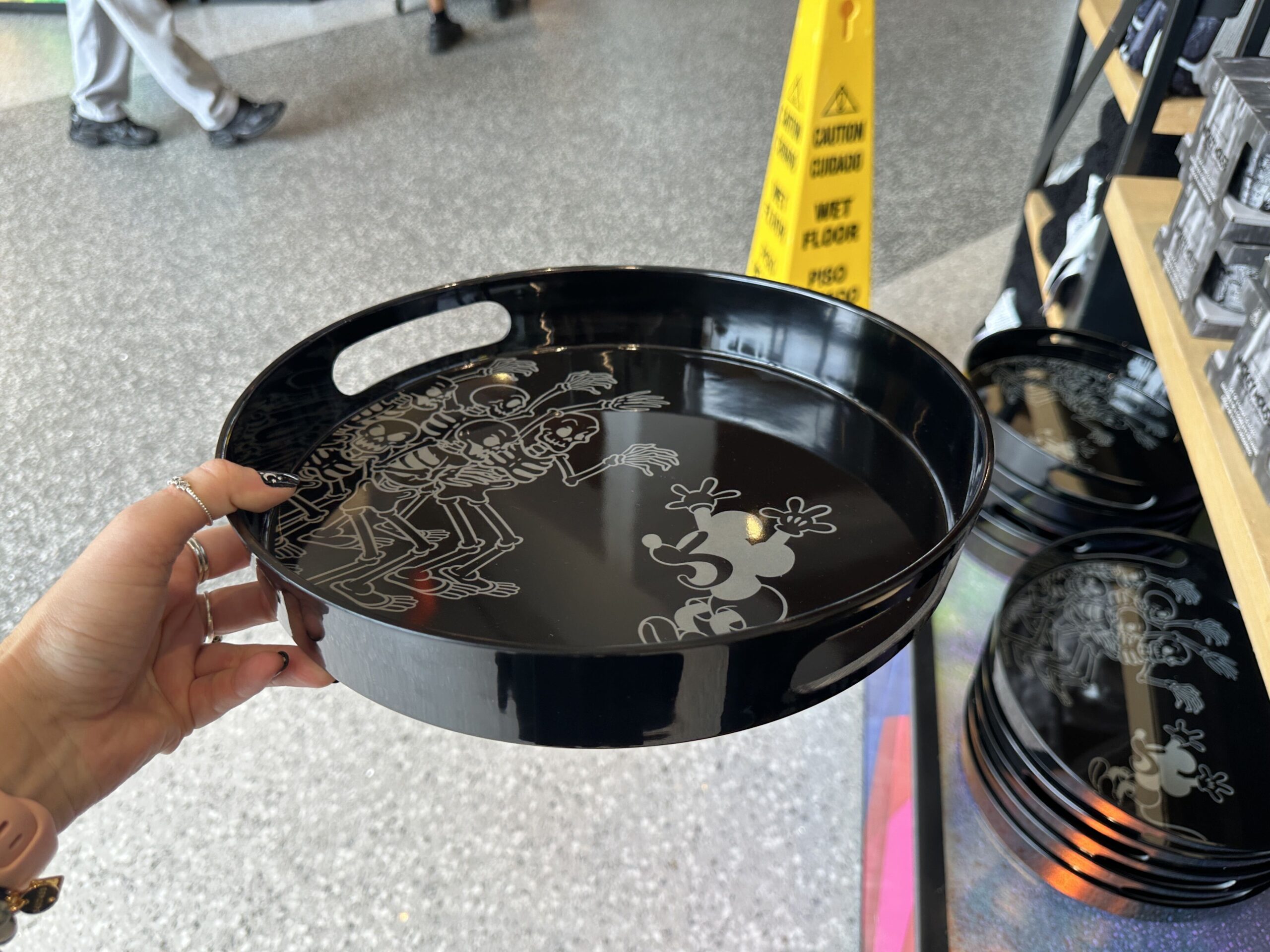 Mickey being scared by the skeletons is depicted on this black tray. Mickey and the skeletons are white outlines.