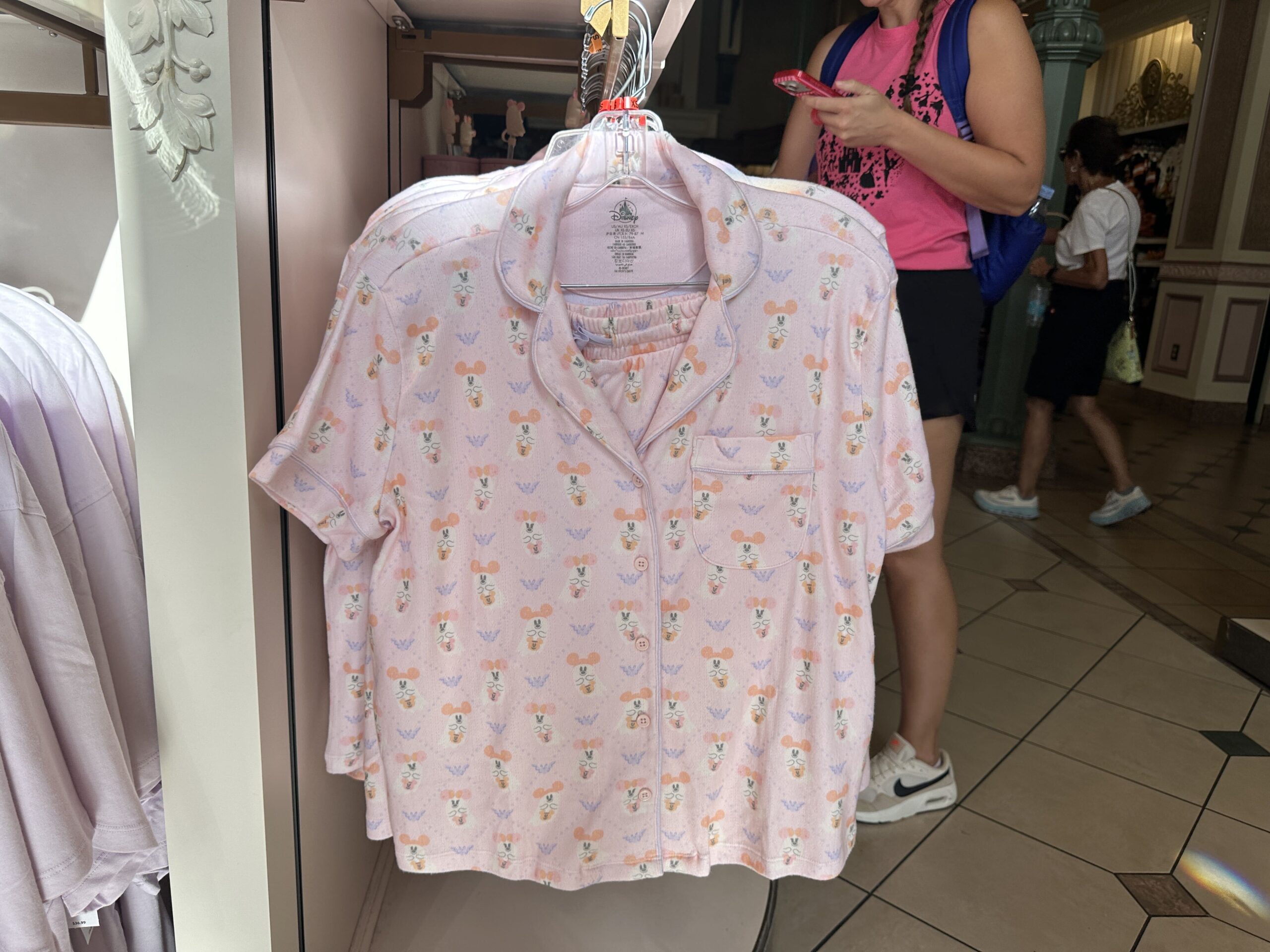 The pastel pajama shirt and shorts sleep set features an allover print of Mickey and Minnie ghosts.