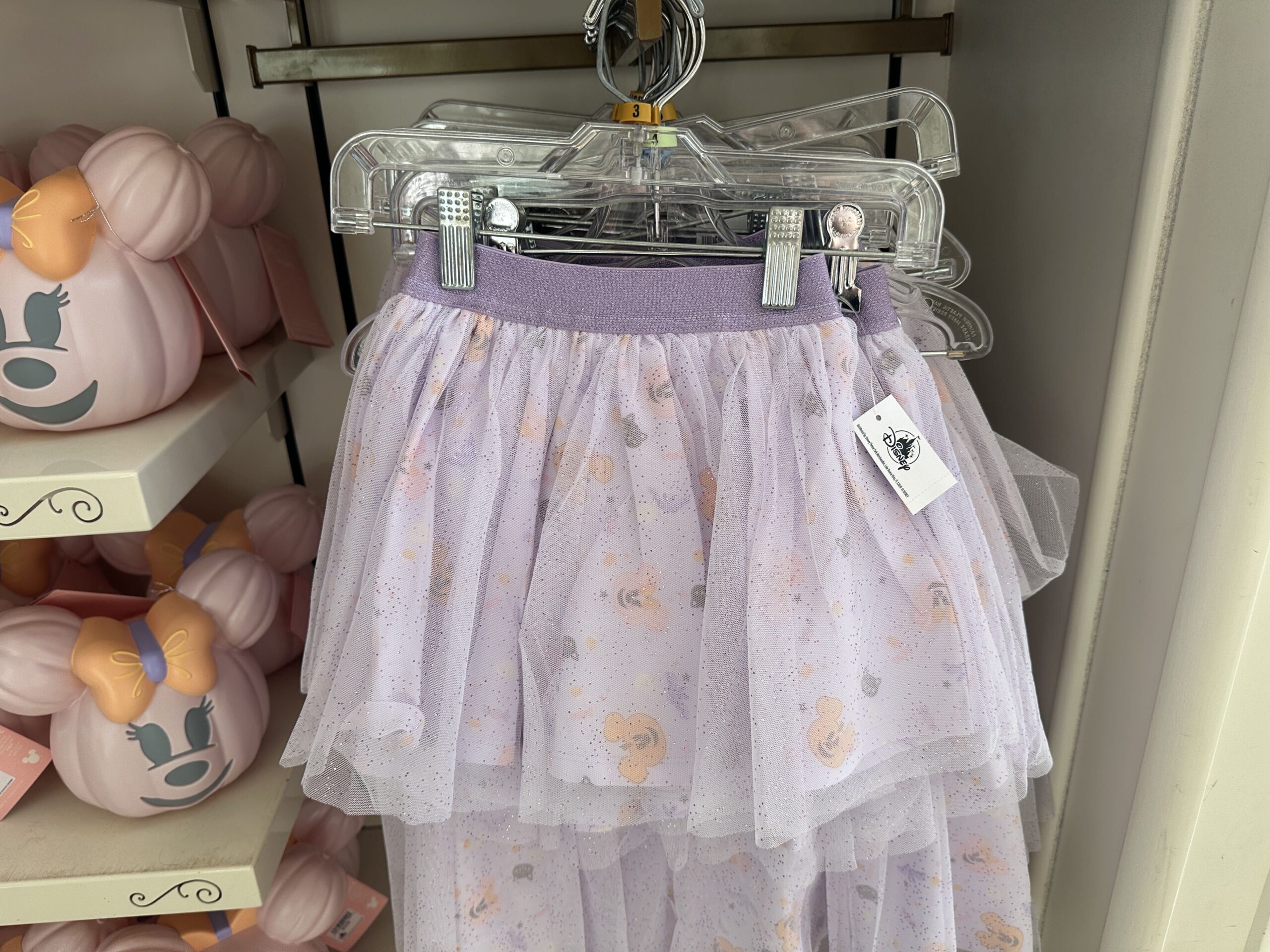 The purple tulle skirt has Mickey jack-o'-lanterns, bats, candy, and more Halloween-themed images.