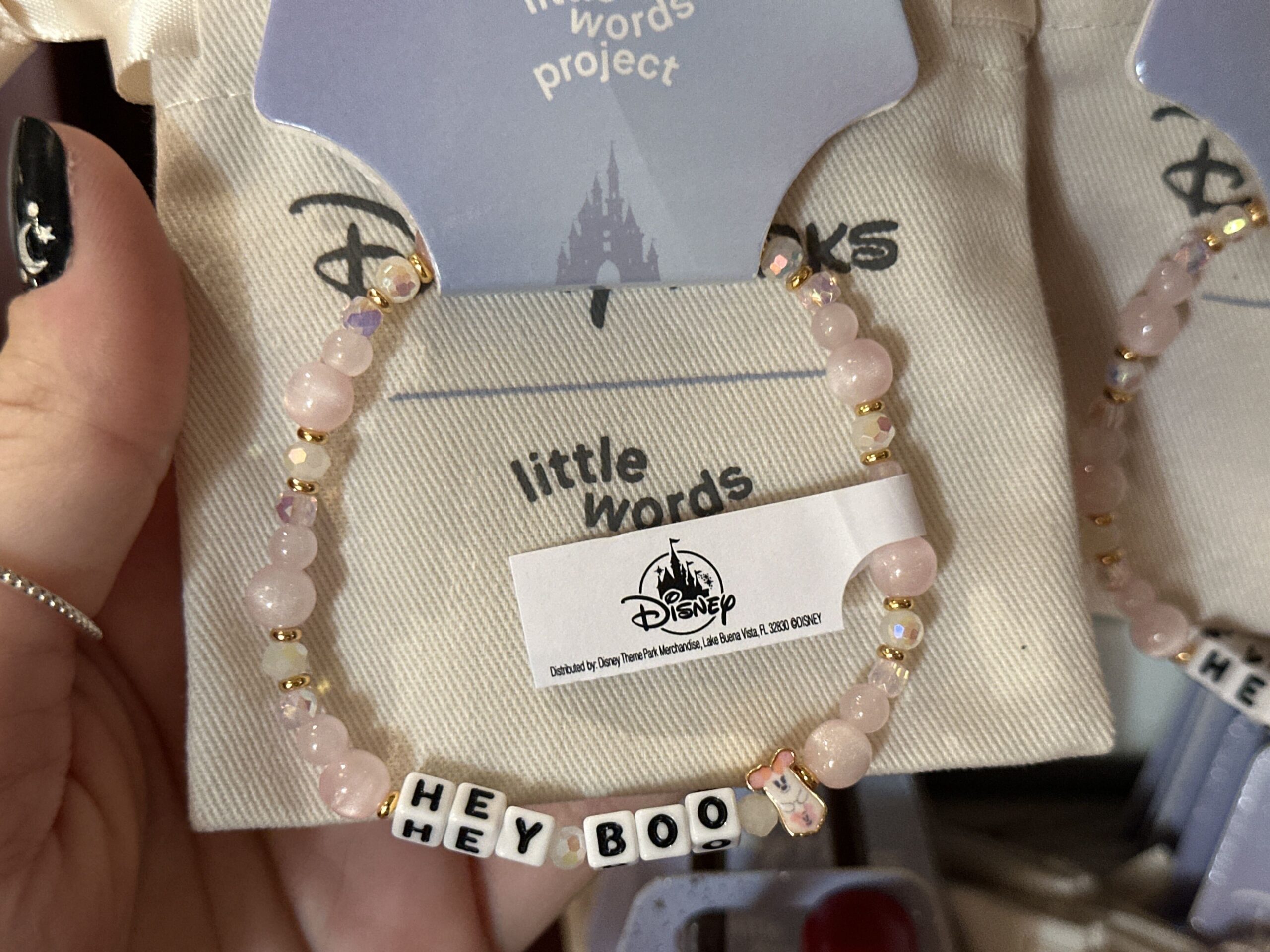 "Hey Boo" is spelled out in white letter beads. A Minnie ghost charm is on the end, and pearlescent accent beads cover the rest of the bracelet.