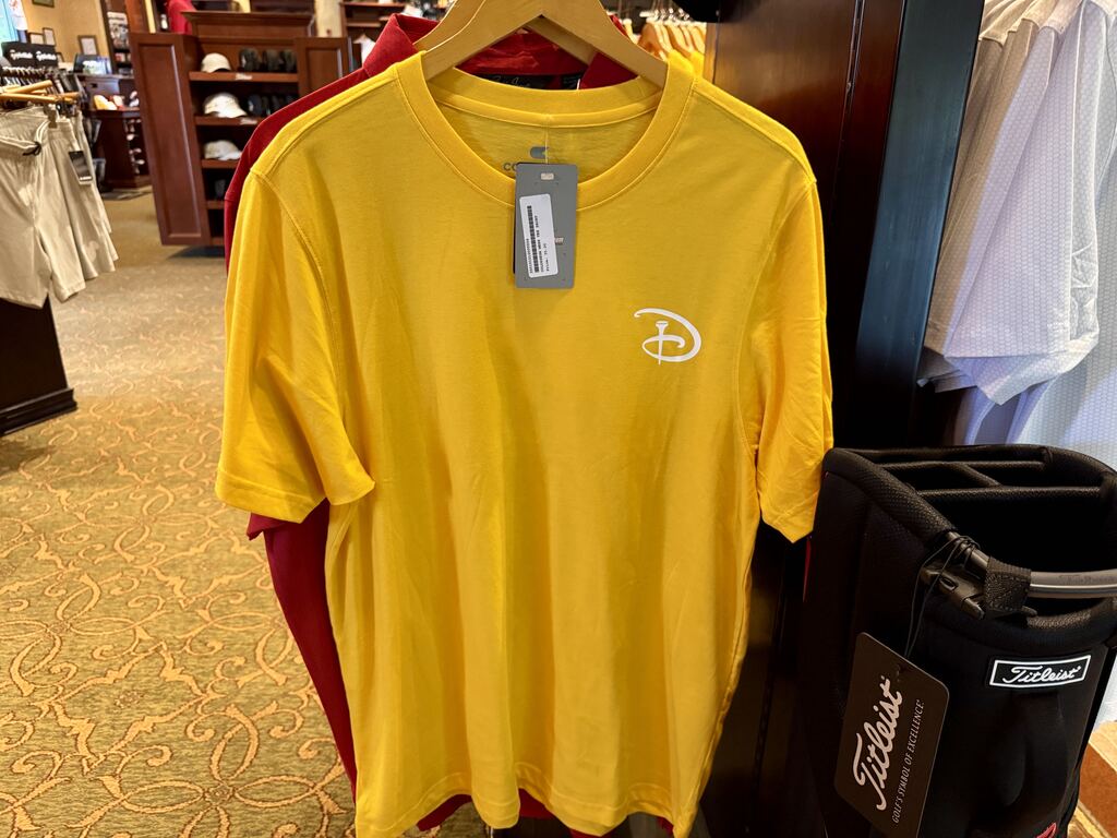 Yellow golf shirt available at Palm and Magnolia pro shop at Walt Disney World