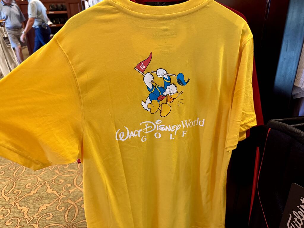 Yellow golf shirt available at Palm and Magnolia pro shop at Walt Disney World