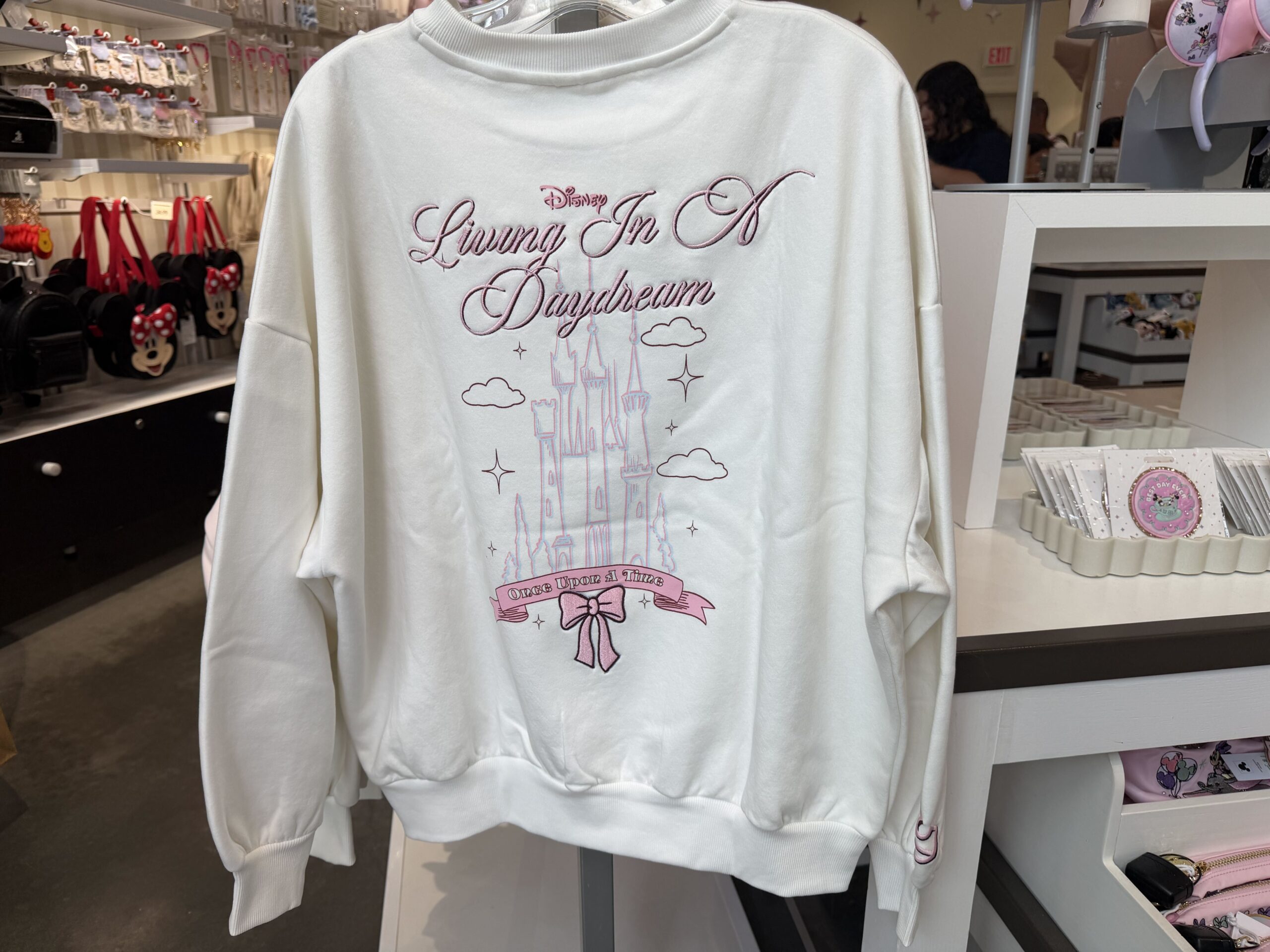 Three new Disney tops by Skinnydip London have arrived at Disney Ever After in Disney Springs, featuring pastel colors, Cinderella Castle, and phrases inspired by Disney dreams.