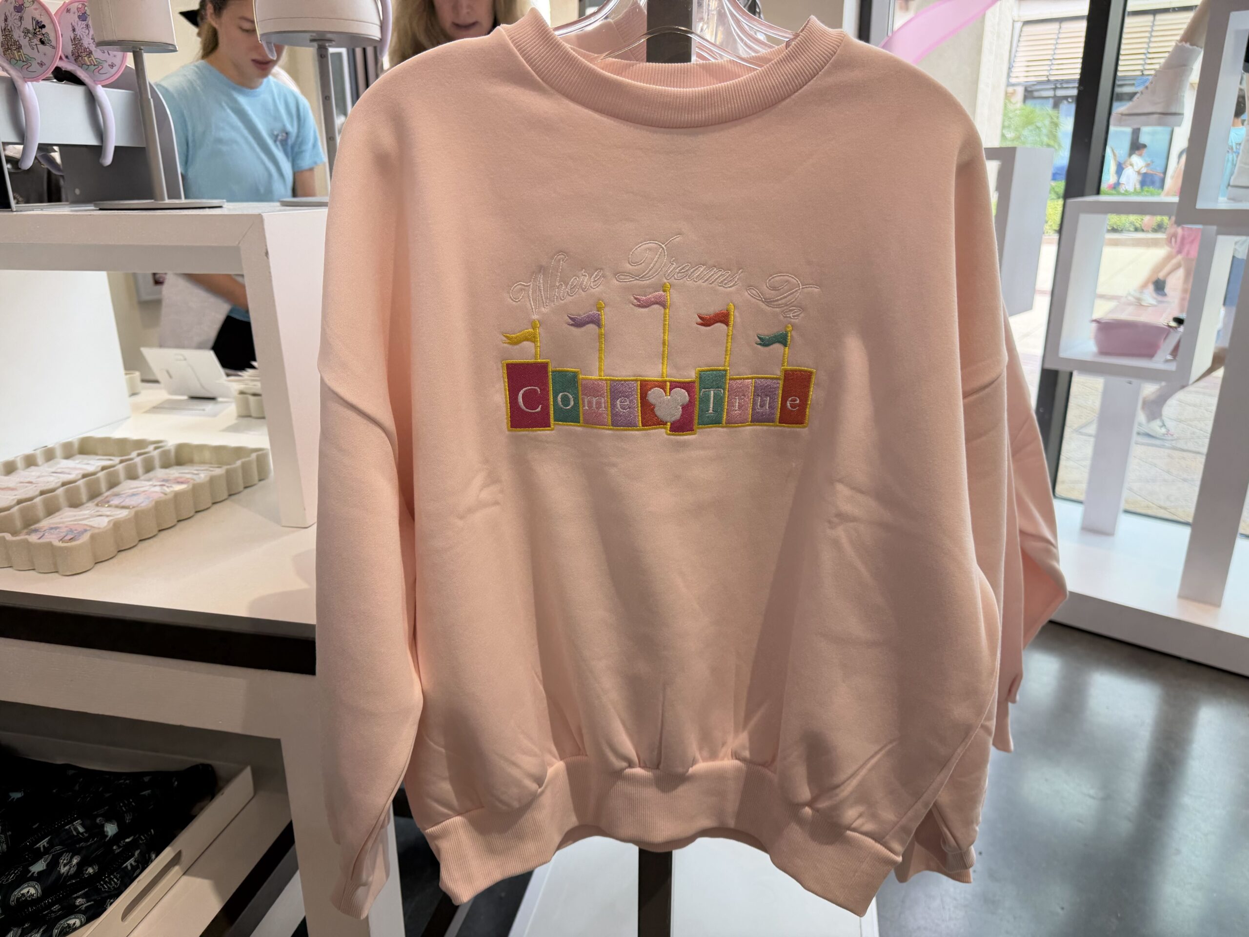 Three new Disney tops by Skinnydip London have arrived at Disney Ever After in Disney Springs, featuring pastel colors, Cinderella Castle, and phrases inspired by Disney dreams.