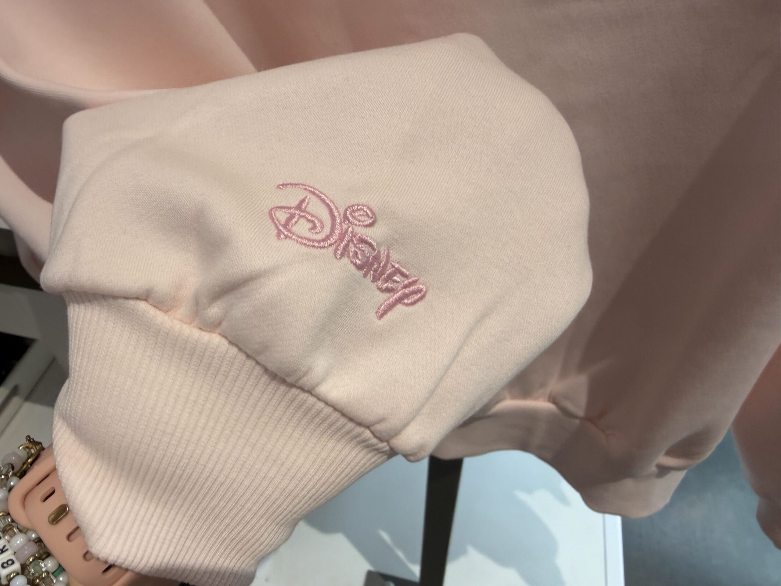 Three new Disney tops by Skinnydip London have arrived at Disney Ever After in Disney Springs, featuring pastel colors, Cinderella Castle, and phrases inspired by Disney dreams.