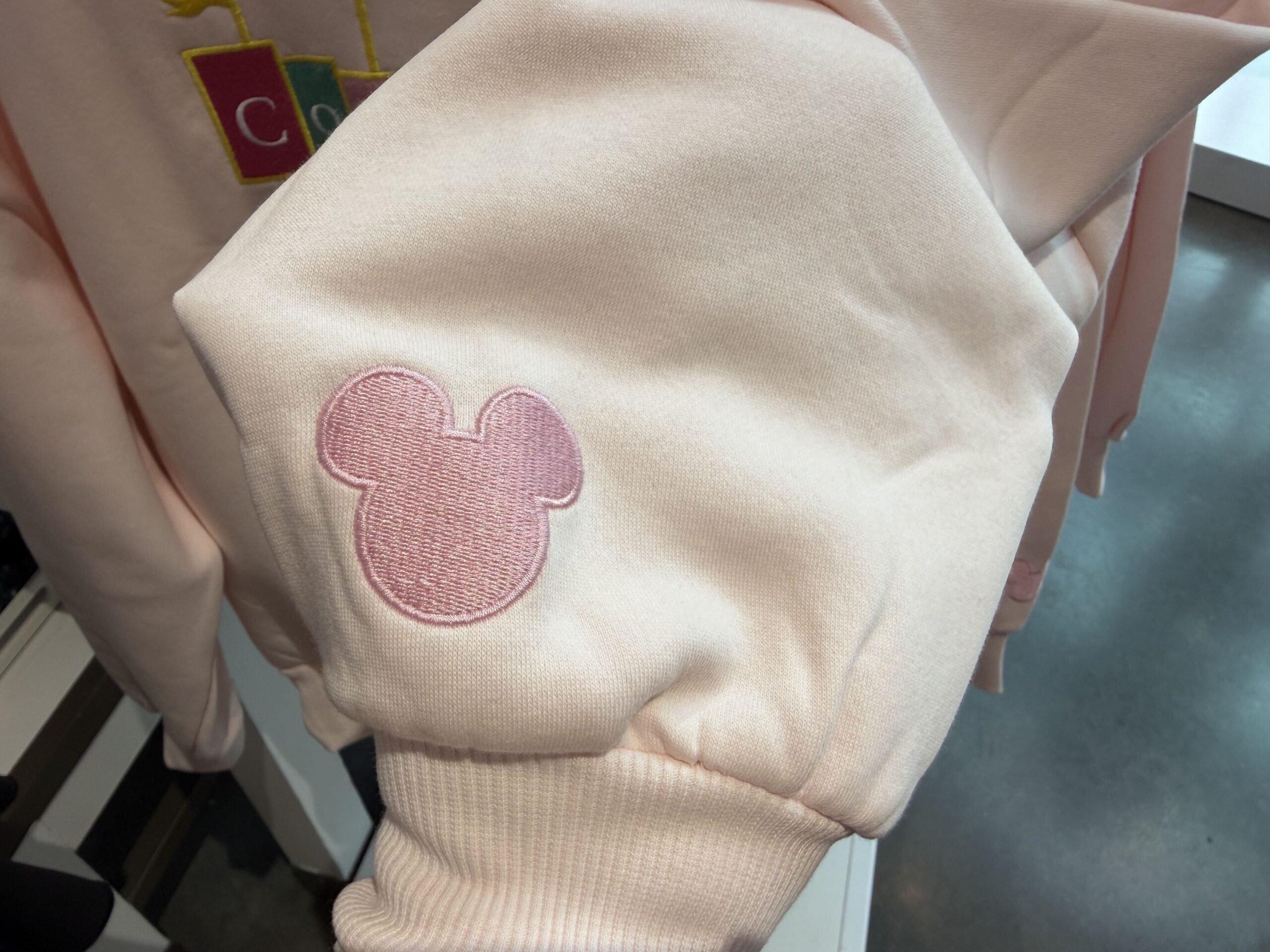 Three new Disney tops by Skinnydip London have arrived at Disney Ever After in Disney Springs, featuring pastel colors, Cinderella Castle, and phrases inspired by Disney dreams.