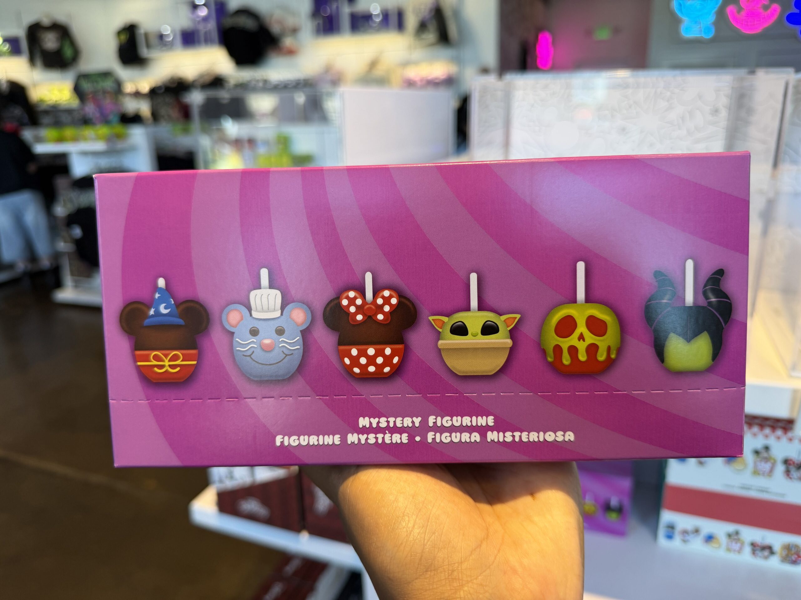 This Mystery Box Set contains six figurines of miniature replica caramel apples themed as Disney favorites. Sorcerer Mickey, Minnie Mouse, Chef Remy, The Poison Apple, Maleficent, and Grogu (or "Baby Yoda," as some might call him).