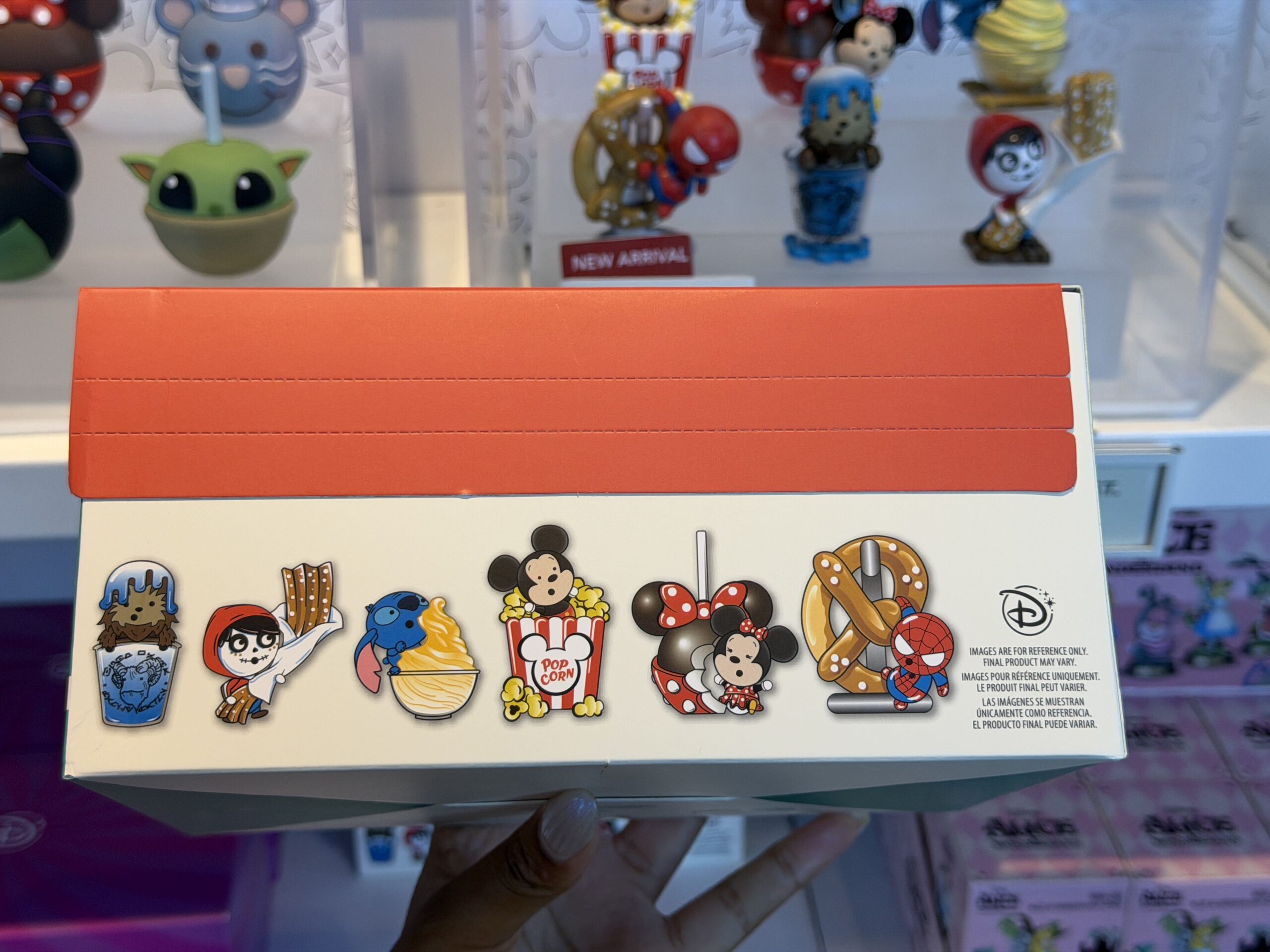 This Mystery Box Set contains six figurines of miniature Disney characters, each paired with a giant version of a snack from the Disney Parks. Mickey Mouse is paired with a box of popcorn, Minnie Mouse is paired with a caramel apple themed to her signature bow-and-polka dot look, Stitch is licking a Dole Whip, Spider-Man hangs from a Pym's soft pretzel, Chewbacca pops up from inside of a cup of Blue Milk, and Miguel holds a cinnamon-dusted churro. 
The characters are animated in a "cutsie," "chou-chou" style.